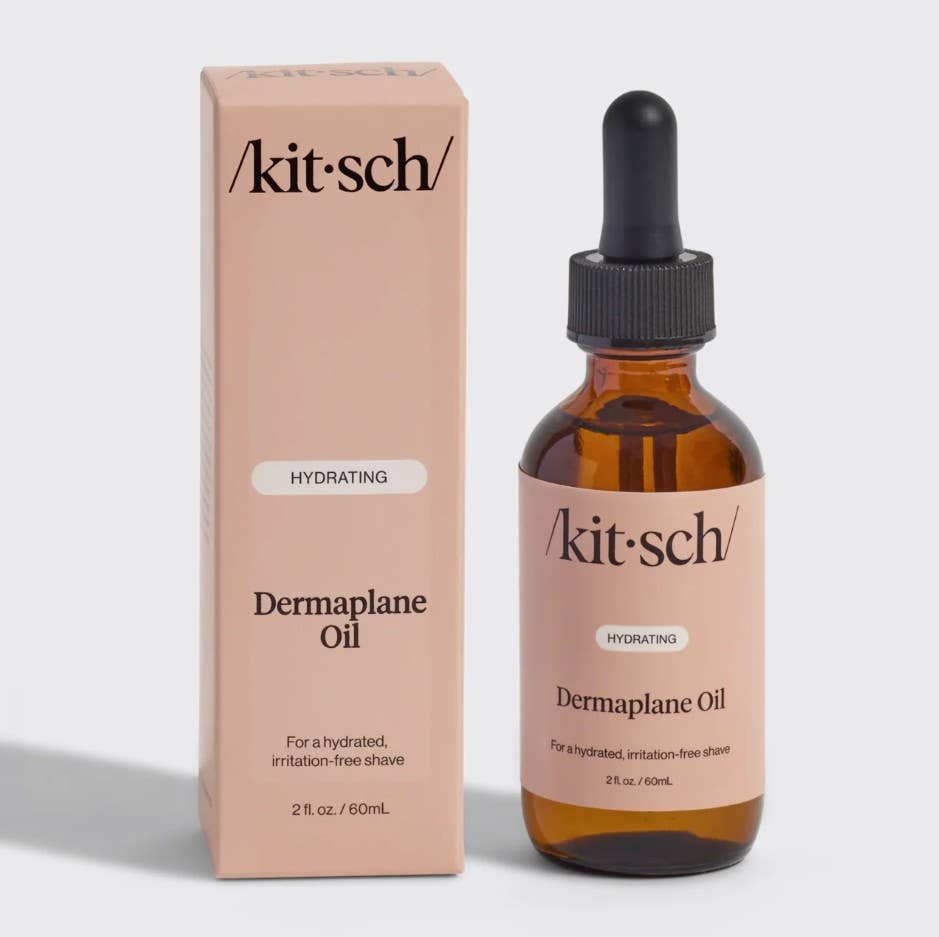 Kit-sch Dermaplane Oil bottle and packaging on a light gray background